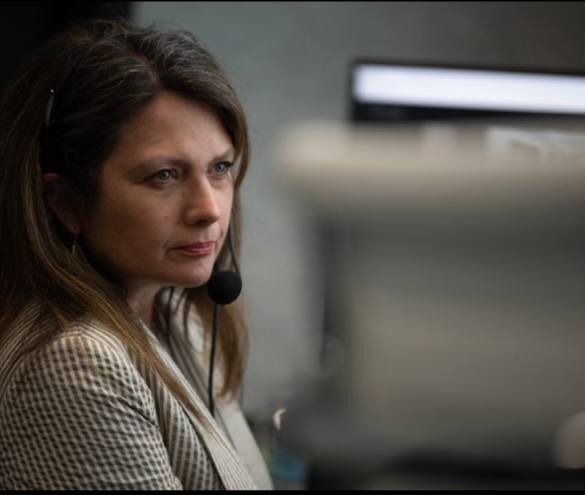 A woman wearing a headset.